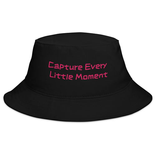 Black bucket hat from Petals & Ash Studio with "Capture Every Little Moment" text, casual style, front view.