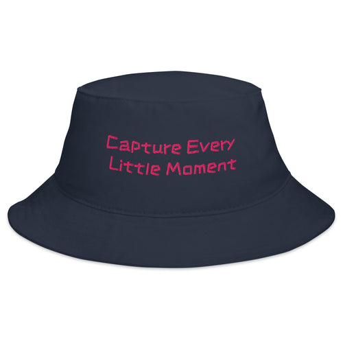 Navy bucket hat with "Capture Every Little Moment" embroidered text, casual style, by Petals & Ash Studio.