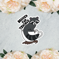 Raccoon Brewed for Trouble sticker by Petals & Ash Studio, die-cut satin finish 4x4 inch design featuring a playful raccoon illustration.