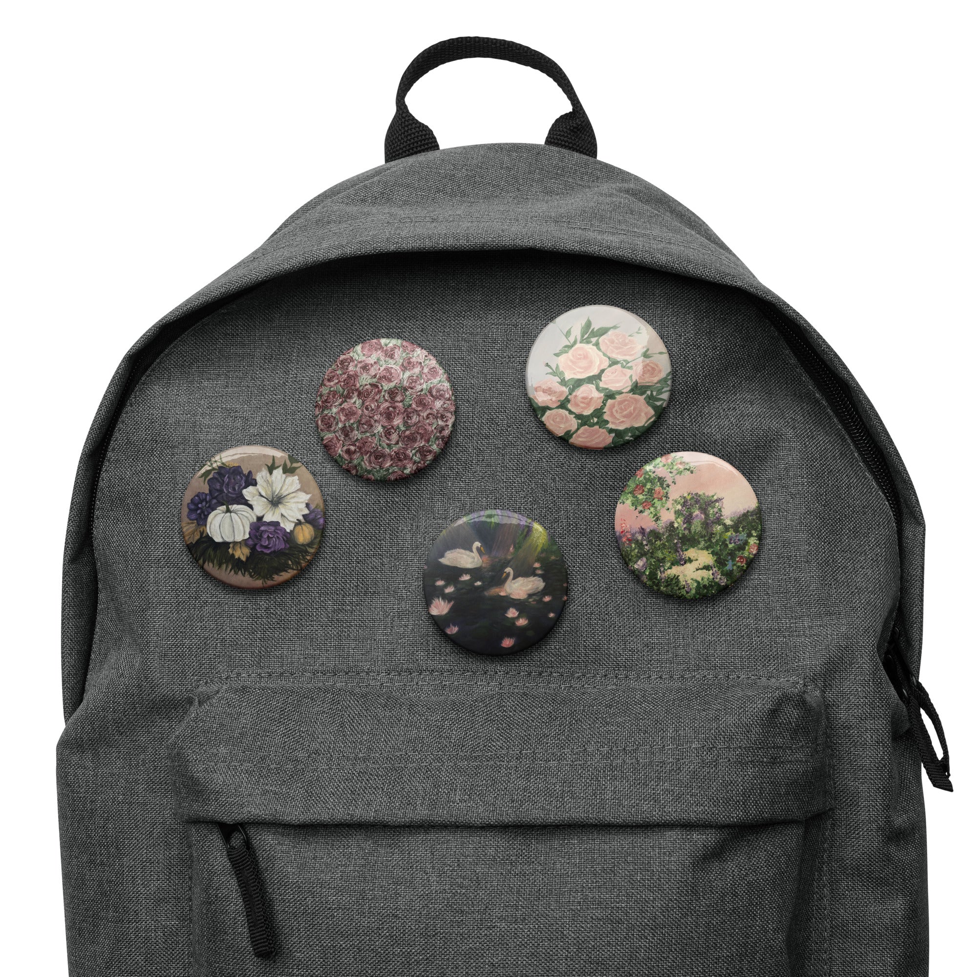 Set of white artwork pin buttons from Petals & Ash Studio, featuring colorful designs on 2.25-inch round pins.