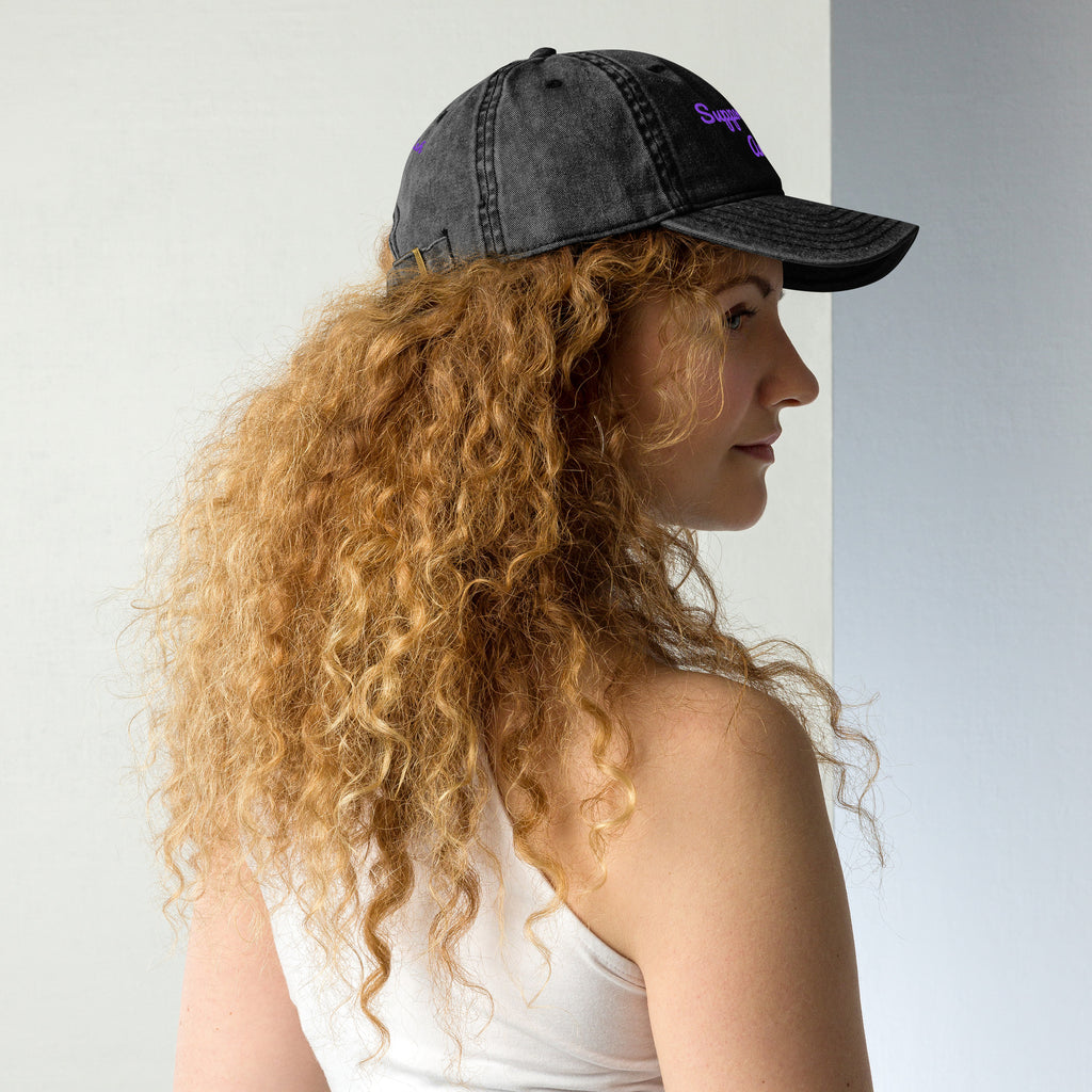 Black vintage cotton twill cap with "Support Local Artists" embroidery, worn on a model's right back side. Petals & Ash Studio.